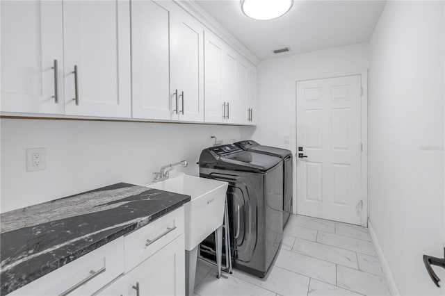 washroom with separate washer and dryer and cabinets