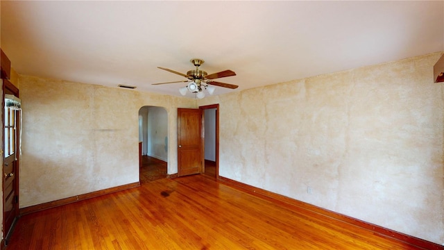 spare room with hardwood / wood-style floors and ceiling fan