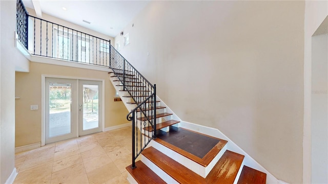 1149 Sedeeva St, Clearwater, FL 33755 - stairs featuring baseboards, a high ceiling, and french doors