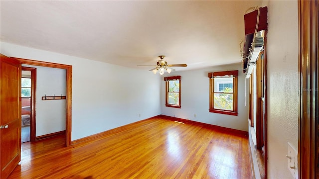 1149 Sedeeva St, Clearwater, FL 33755 - spare room featuring baseboards, a ceiling fan, light wood-style flooring, and a healthy amount of sunlight