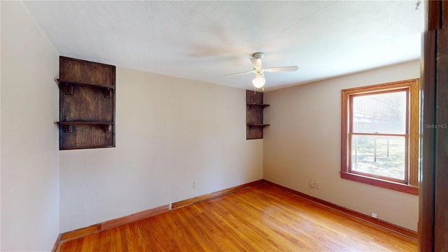 1149 Sedeeva St, Clearwater, FL 33755 - empty room featuring a ceiling fan, light wood-style flooring, and baseboards