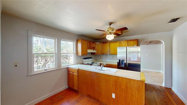1149 Sedeeva St, Clearwater, FL 33755 - kitchen featuring stainless steel fridge with ice dispenser, under cabinet range hood, electric range, a sink, and visible vents