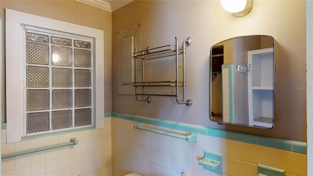 1149 Sedeeva St, Clearwater, FL 33755 - bathroom featuring tile walls and a wainscoted wall