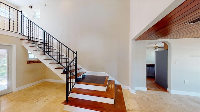 1149 Sedeeva St, Clearwater, FL 33755 - stairs with a towering ceiling, arched walkways, and baseboards
