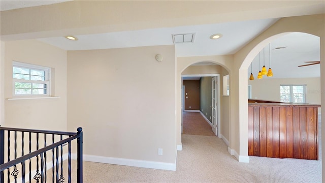 1149 Sedeeva St, Clearwater, FL 33755 - hallway featuring arched walkways, baseboards, recessed lighting, and light carpet