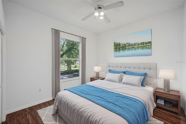 bedroom with ceiling fan and dark wood-type flooring