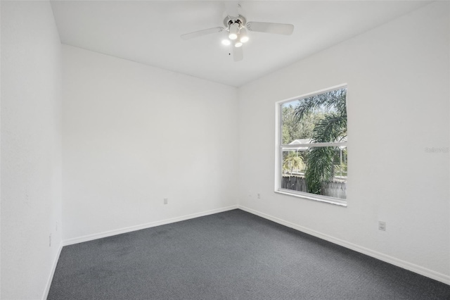 unfurnished room with dark carpet and ceiling fan