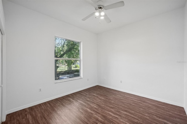 empty room with ceiling fan and dark wood-type flooring