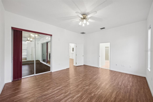 interior space featuring wood-type flooring, a textured ceiling, and ceiling fan