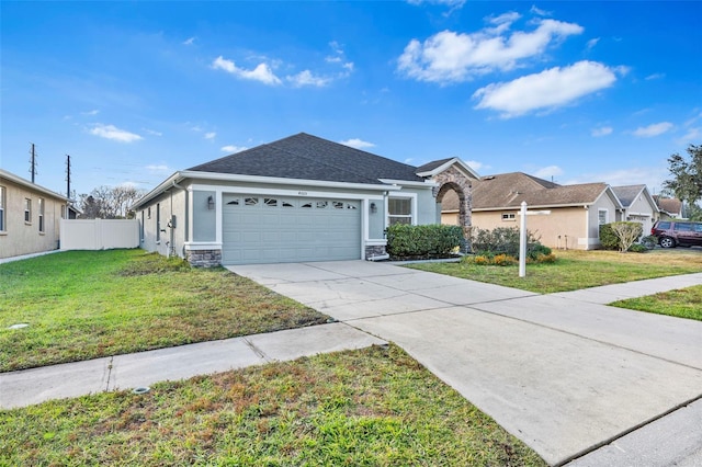 ranch-style house featuring a front lawn and a garage