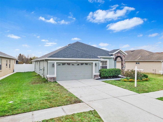 ranch-style house with a garage and a front lawn