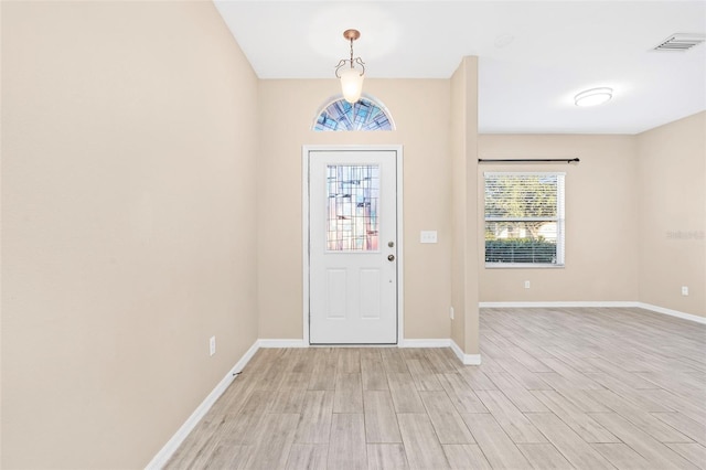 foyer entrance with light hardwood / wood-style floors