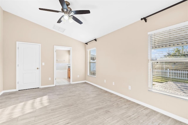 empty room featuring ceiling fan, light hardwood / wood-style flooring, and lofted ceiling