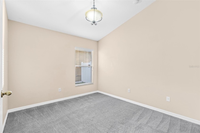 unfurnished room featuring carpet and lofted ceiling