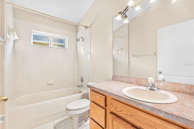 full bathroom featuring toilet, vanity, tile patterned floors, and tiled shower / bath