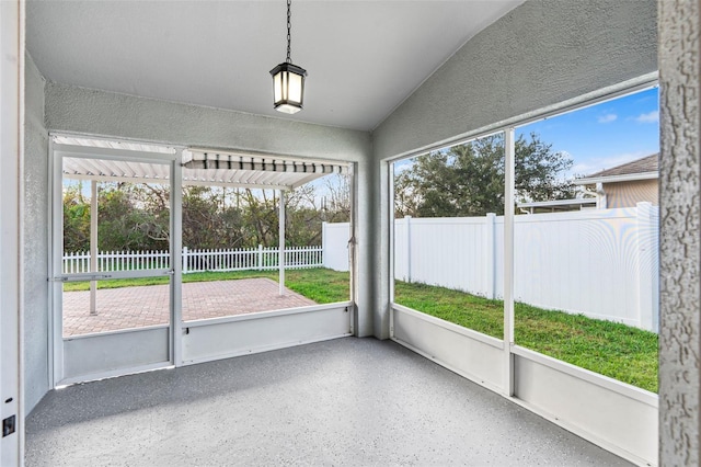 unfurnished sunroom featuring lofted ceiling