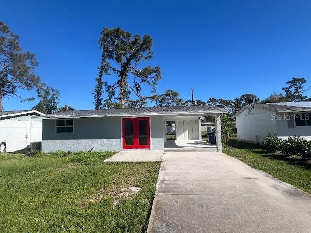 ranch-style house featuring central AC unit and a front yard