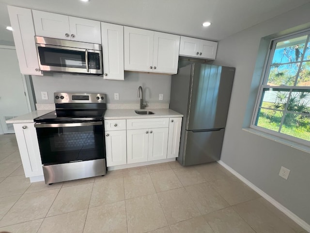 kitchen featuring white cabinetry, a wealth of natural light, and stainless steel appliances