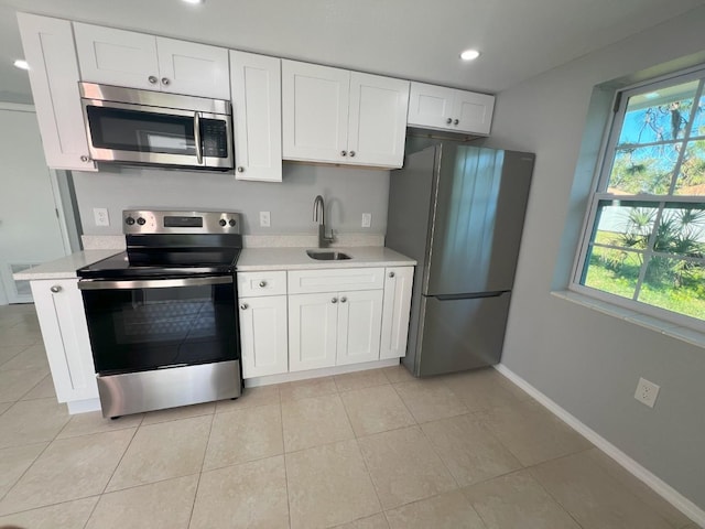 735 Bertrend St, Englewood, FL 34223 - kitchen featuring stainless steel appliances, a sink, light countertops, healthy amount of natural light, and recessed lighting