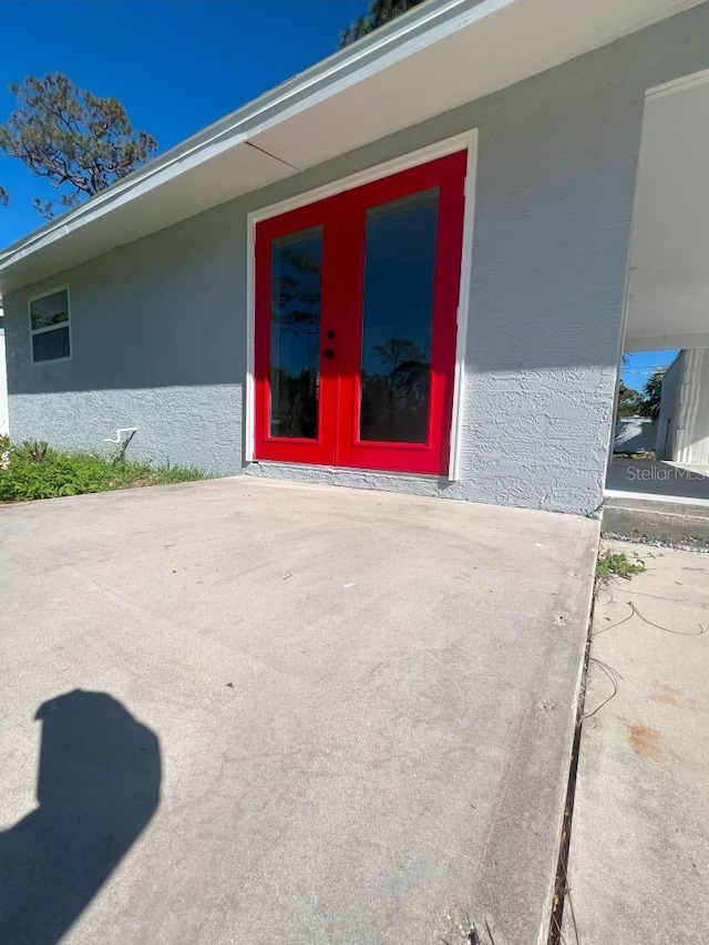 735 Bertrend St, Englewood, FL 34223 - view of exterior entry featuring stucco siding and a patio area