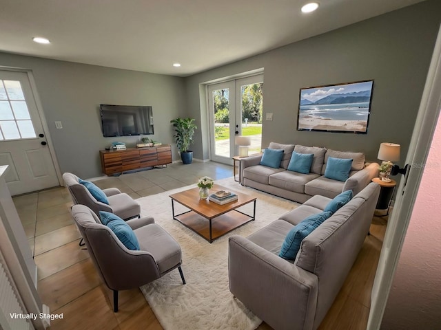 living room with light tile patterned flooring, a wealth of natural light, and french doors