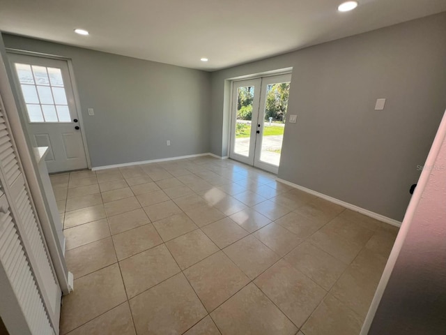 735 Bertrend St, Englewood, FL 34223 - unfurnished room featuring french doors, plenty of natural light, light tile patterned floors, recessed lighting, and baseboards