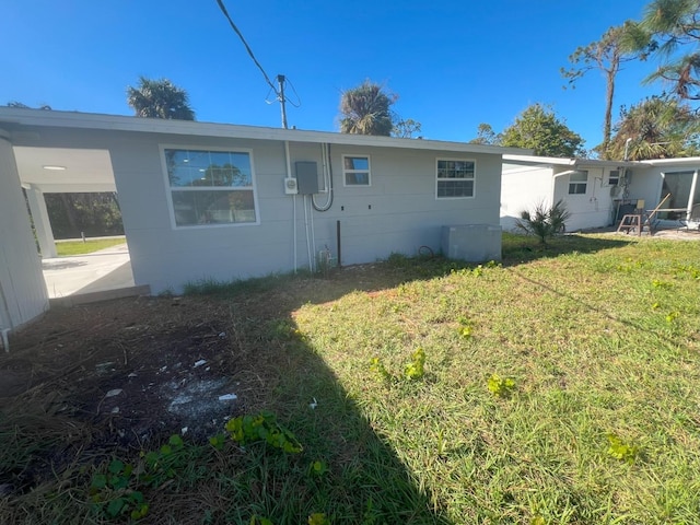 rear view of property with a lawn