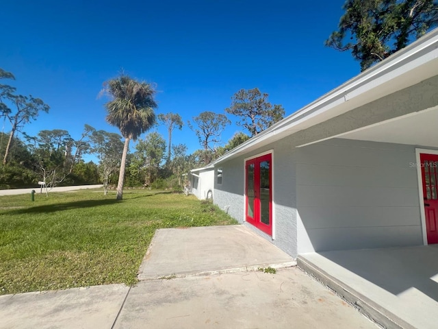 735 Bertrend St, Englewood, FL 34223 - view of grassy yard with french doors and a patio area