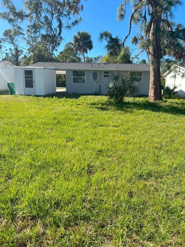 rear view of house with a lawn