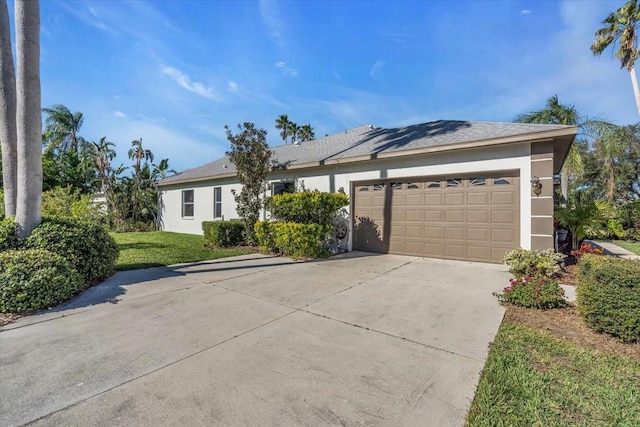 ranch-style house with a front yard and a garage