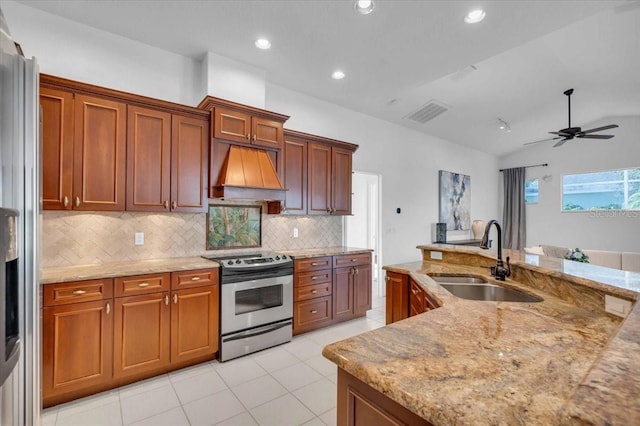 kitchen featuring premium range hood, stainless steel appliances, vaulted ceiling, ceiling fan, and sink