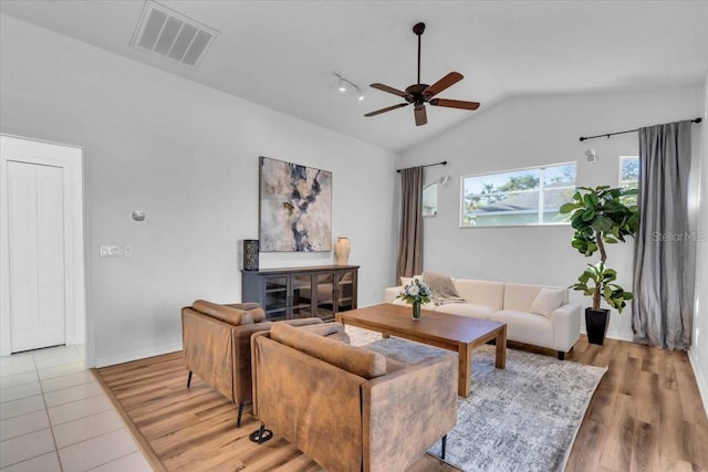 living room with ceiling fan, wood-type flooring, and vaulted ceiling