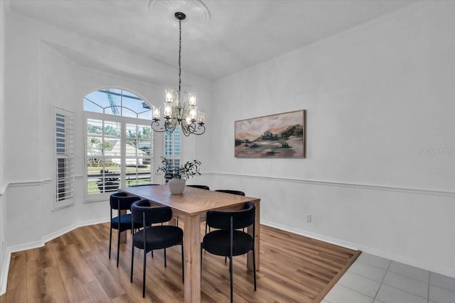 dining space with a chandelier and wood-type flooring