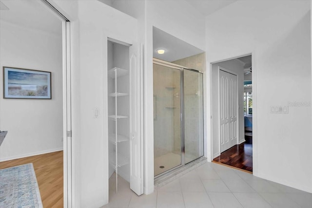 bathroom with hardwood / wood-style flooring and walk in shower