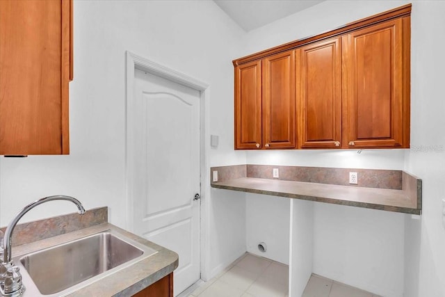 kitchen featuring light tile patterned floors and sink