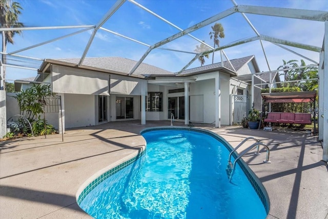 view of swimming pool with a lanai and a patio area