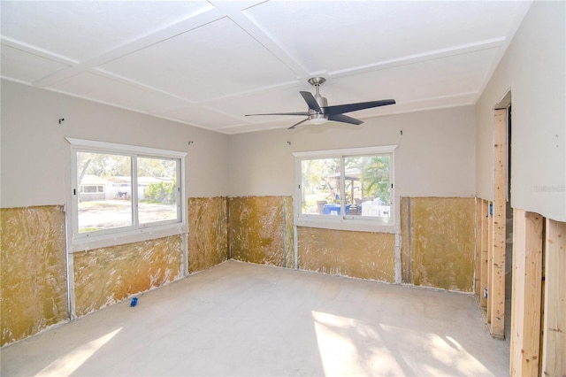 empty room featuring a wealth of natural light and ceiling fan