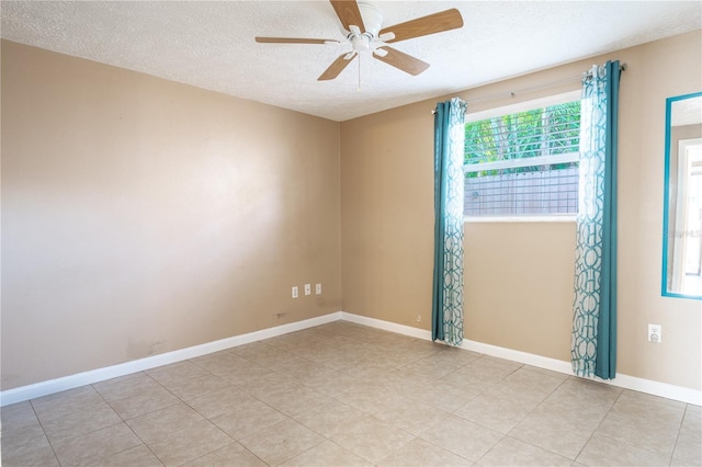 empty room featuring ceiling fan and a textured ceiling