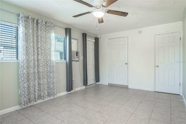 unfurnished bedroom with a textured ceiling, ceiling fan, and light tile patterned flooring