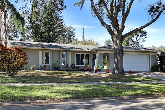 ranch-style home featuring a front lawn and a garage