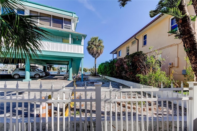 view of property's community with a fenced front yard and a carport