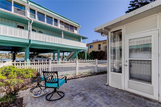 view of patio featuring fence and a carport