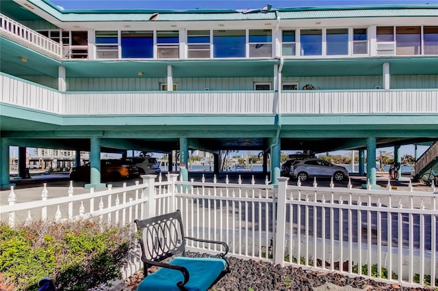 view of community with a carport and fence