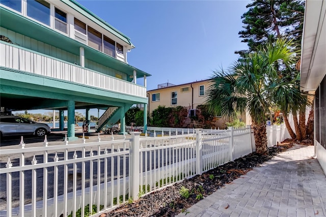 exterior space featuring a fenced front yard and stairway