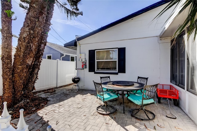 view of patio featuring outdoor dining space and fence