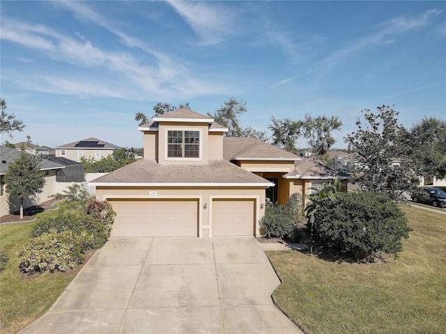 view of front of property featuring a front yard and a garage