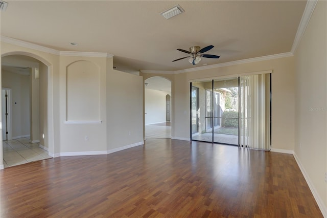 empty room with wood-type flooring, ceiling fan, and crown molding