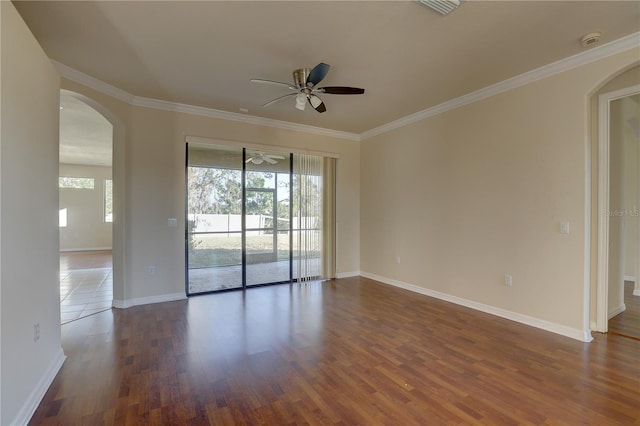 empty room featuring dark hardwood / wood-style floors, ceiling fan, and ornamental molding