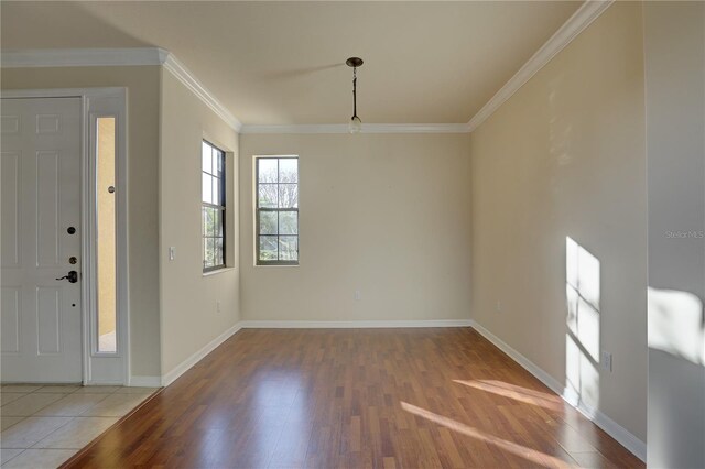 entryway with crown molding and hardwood / wood-style floors