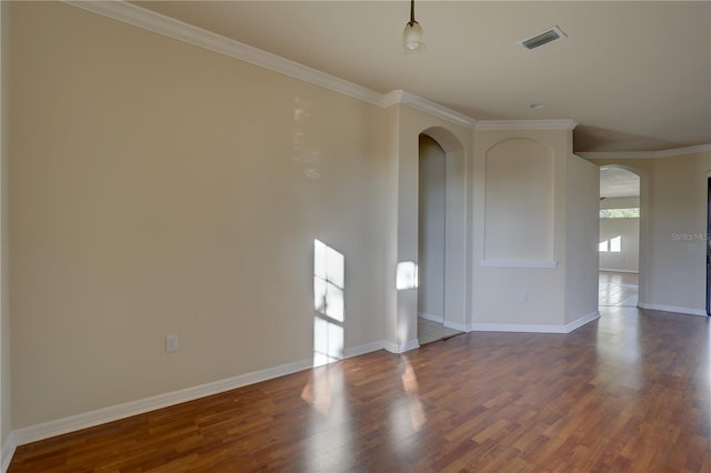 spare room with hardwood / wood-style floors and ornamental molding